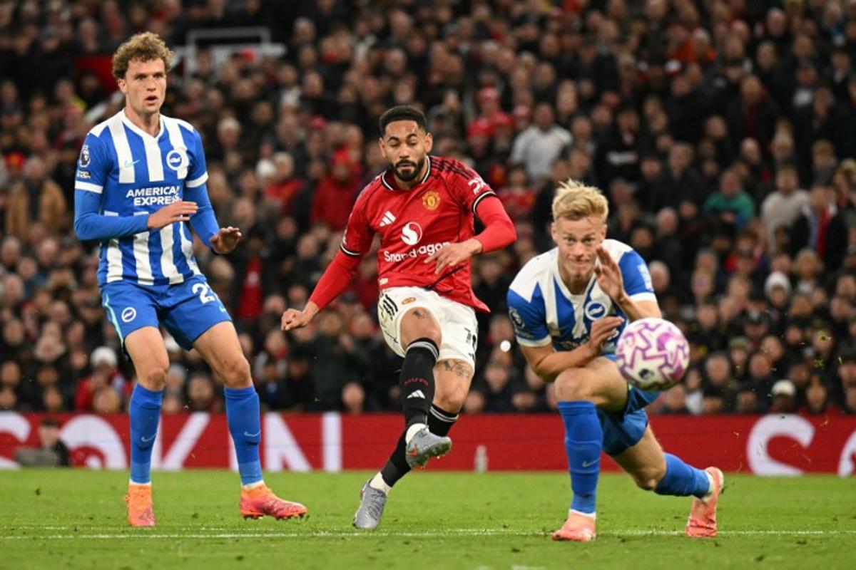 Manchester United's Brazilian striker #10 Matheus Cunha (C) shoots to score the opening goal for 1-0 during the English Premier League football match between Manchester United and Brighton and Hove Albion at Old Trafford in Manchester, north west England, on October 25, 2025.  Oli SCARFF / AFP