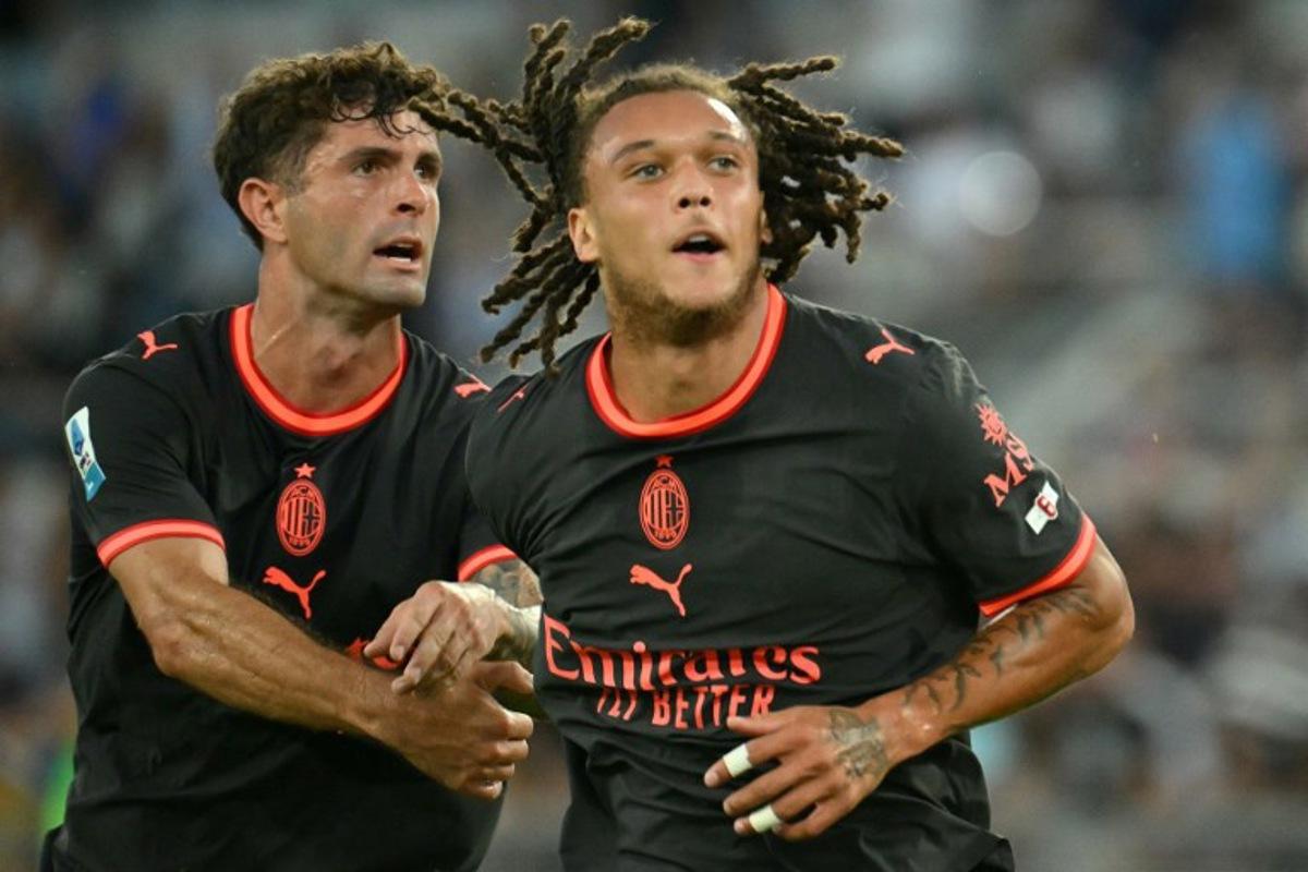 AC Milan's Belgian midfielder #22 Diego Moreira (R) celebrates after scoring Milan's second goal during the Italian Serie A football match between Lazio and AC Milan at the Olympic Stadium in Rome on September 12, 2026.  Alberto PIZZOLI / AFP