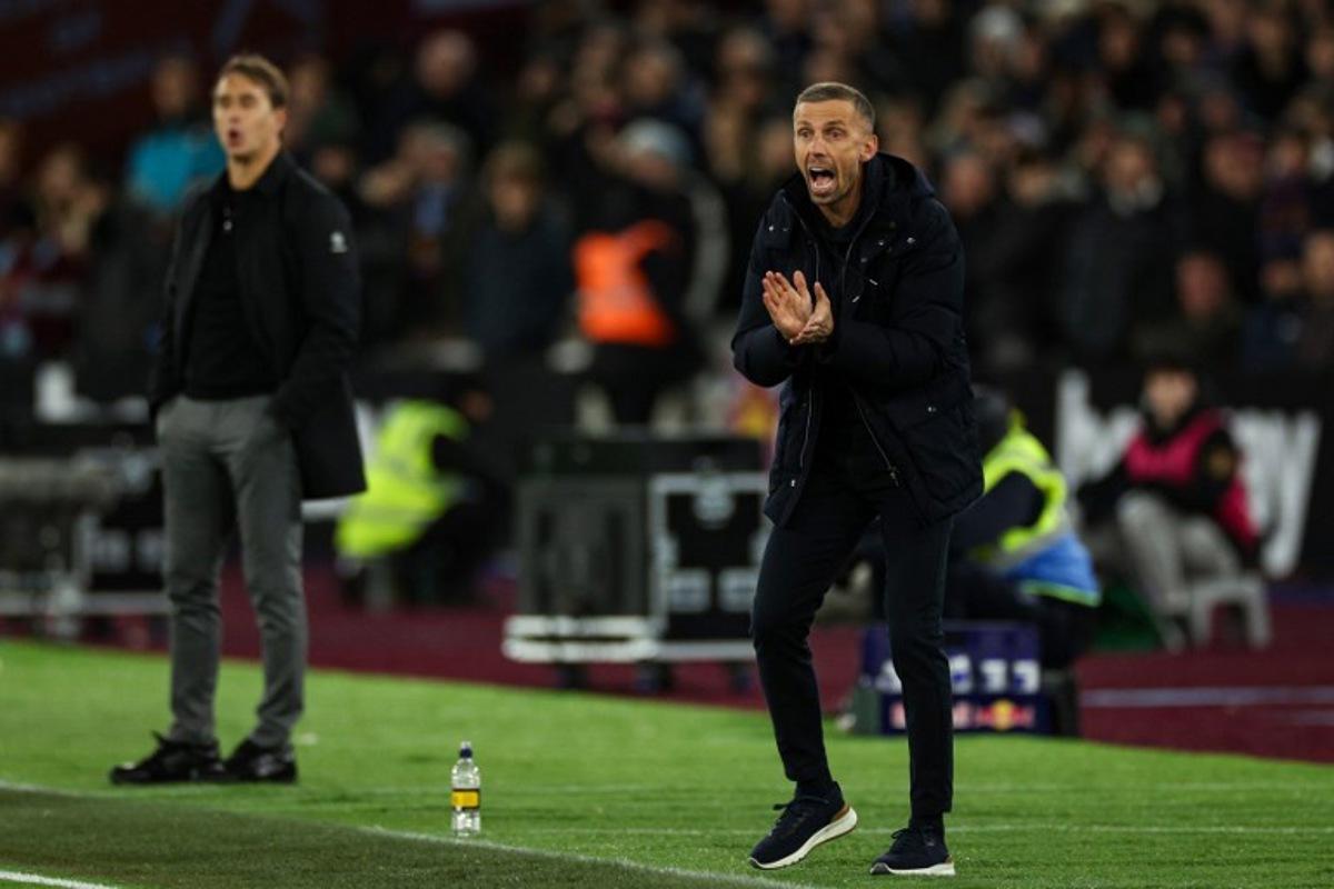 Wolverhampton Wanderers' English head coach Gary O'Neil (R) reacts next to West Ham United's Spanish manager Julen Lopetegui during the English Premier League football match between West Ham United and Wolverhapton Wanderers at the London Stadium, in London on December 9, 2024.  Adrian Dennis / AFP