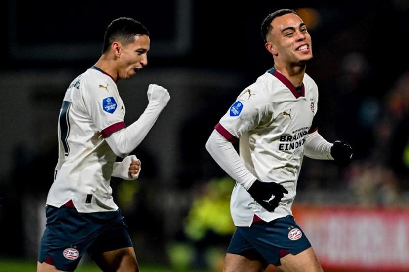 PSV's US midfielder #08 Sergino Dest (R) celebrates scoring his team's first goal with teammate PSV's Brazilian defender #17 Mauro Junior (L) during the Dutch Eredivisie football match between Go Ahead Eagles and PSV Eindhoven at De Adelaarshorst stadium in Deventer on March 8, 2024.  Gerrit van Keulen / ANP / AFP