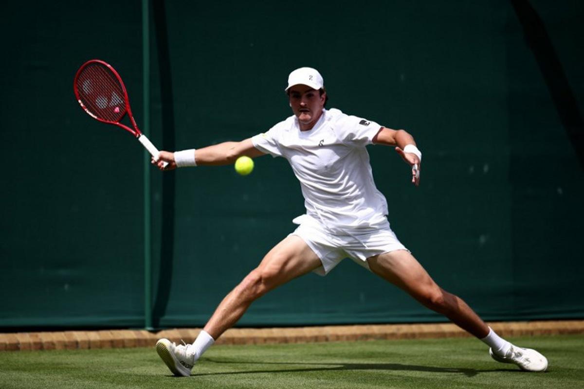 Brazil's Joao Fonseca returns to Spain's Roberto Bautista Agut during their men's singles first round tennis match on the first day of the 2026 Wimbledon Championships at The All England Lawn Tennis and Croquet Club in Wimbledon, southwest London, on June 29, 2026.  Henry NICHOLLS / AFP