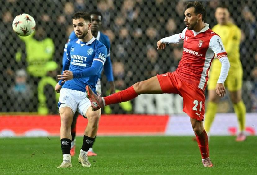 Sporting Braga's Portuguese midfielder #21 Ricardo Horta (R) vies with Rangers' Belgian midfielder #43 Nicolas Raskin during the UEFA Europa League league-stage football match between Rangers and CS Braga at the Ibrox Stadium in Glasgow on November 27, 2025.  ANDY BUCHANAN / AFP