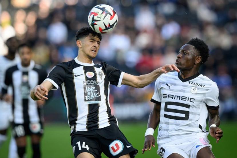 Rennes' Belgian forward #19 Kazeem Olaigbe (R) fights for the ball with Angers' Moroccan midfielder #14 Yassin Belkhdim during the French L1 football match between SCO Angers and Rennes at The Raymond-Kopa Stadium in Angers, western France on March 30, 2025.  Loic VENANCE / AFP