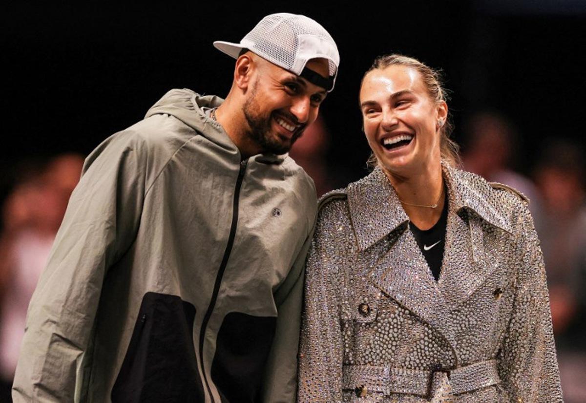 Australia's Nick Kyrgios (L) and Belarus' Aryna Sabalenka share a laugh prior to their Battle of the Sexes exhibition tennis match in Dubai on December 28, 2025.   Amr Alfiky / POOL / AFP