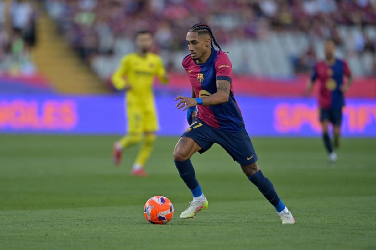 Barcelona's Brazilian forward #11 Raphinha controls the ball during the Spanish league football match between FC Barcelona and Villarreal CF at Estadi Olimpic Lluis Companys in Barcelona on May 18, 2025.  MANAURE QUINTERO / AFP