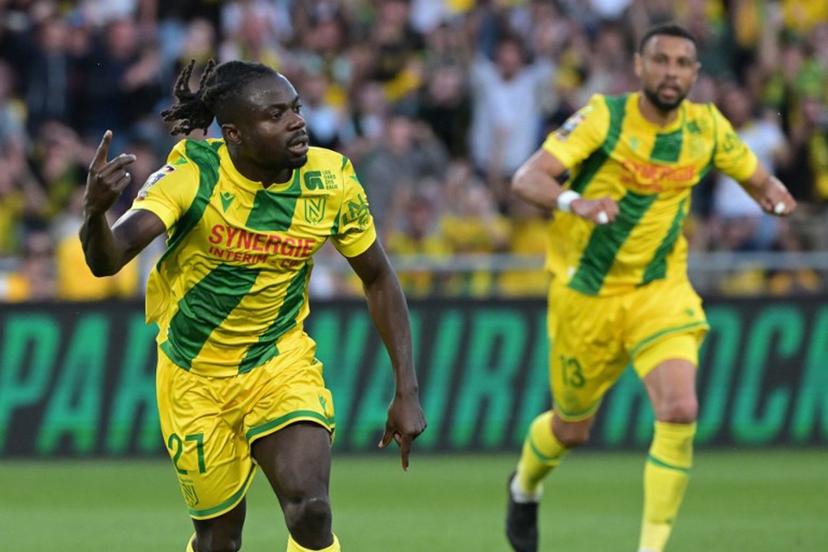 Nantes' Nigerian forward #27 Moses Simon (L) celebrates after scoring a penalty kick for the opening goal  during the French L1 football match between FC Nantes and Montpellier Herault SC at the Stade de la Beaujoire-Louis Fonteneau in Nantes, western France on May 17, 2025.  Damien Meyer / AFP