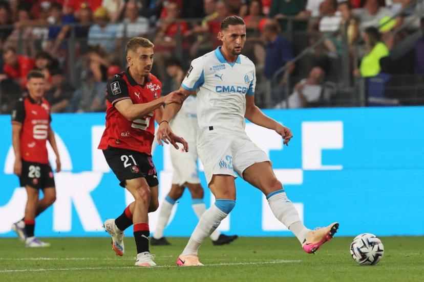 Marseille's French midfielder #25 Adrien Rabiot (R) makes a pass challenged by Rennes' French midfielder #21 Valentin Rongier during the French L1 football match between Stade Rennais FC and Olympique de Marseille (OM) at Roazhon Park stadium in Rennes, western France, on August 15, 2025.  FRED TANNEAU / AFP