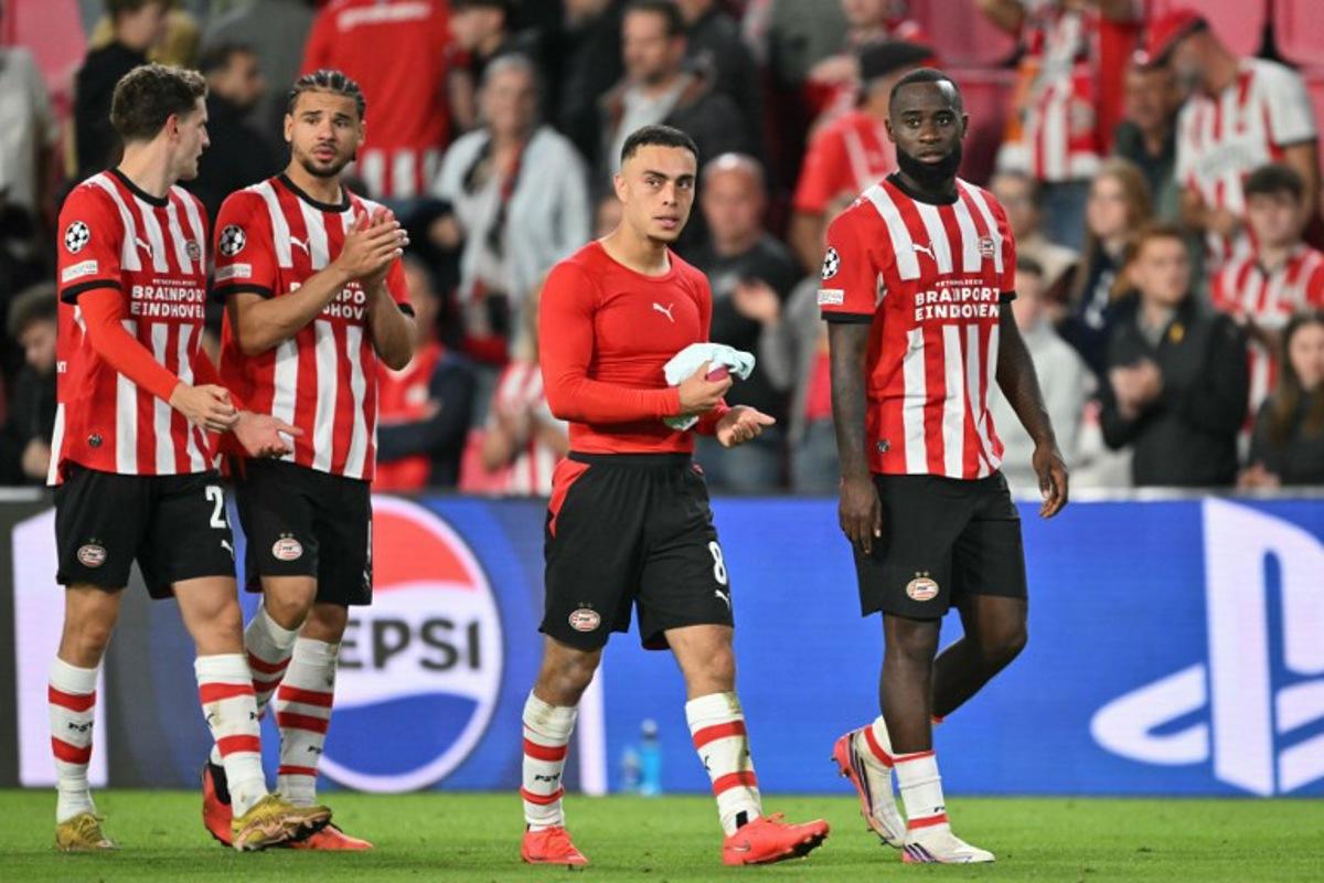 (From L) PSV Eindhoven's Dutch midfielder #20 Guus Til, PSV Eindhoven's Curacaoan defender #04 Armando Obispo, PSV Eindhoven's US defender #08 Sergino Dest and Lutsharel PSV Eindhoven's Dutch defender #02 Lutsharel Geertruida react after a draw in the  UEFA Champions League - League phase, Matchday 1 - football match between PSV Eindhoven and FC Shakhtar Donetsk at the Philips Stadium in Eindhoven on September 10, 2026.  NICOLAS TUCAT / AFP