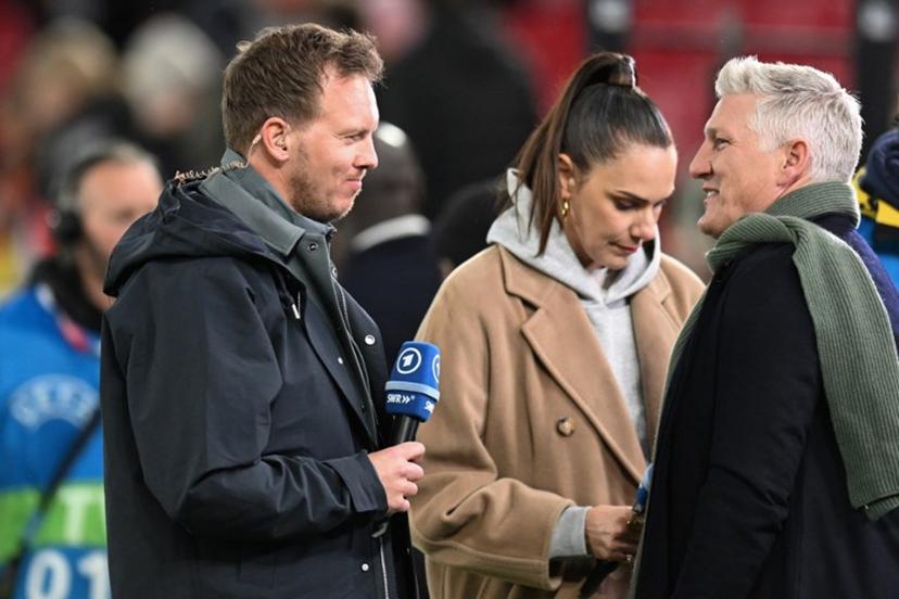 (From L) Germany's head coach Julian Nagelsmann and Germany's former football player Bastian Schweinsteiger speak during an interview prior to the international friendly football match between Germany and Ghana in Stuttgart, southwestern Germany on March 30, 2026.  THOMAS KIENZLE / AFP