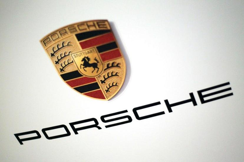 The logo of German car producer Porsche AG is pictured on the sidelines of the launch of the company's initial public offering (IPO) at the Frankfurt Stock Exchange in Frankfurt, western Germany, on September 29, 2022. Luxury sports carmaker Porsche will on September 29, 2022 race onto the Frankfurt stock exchange in what is set to be one of Europe's biggest listings in years, seeking to defy recent market turbulence. Parent company Volkswagen hopes the flotation will raise up to 9.4 billion euros (USD 9.2 billion) and are targeting a valuation of up to 75 billion euros for Porsche. Daniel ROLAND / AFP