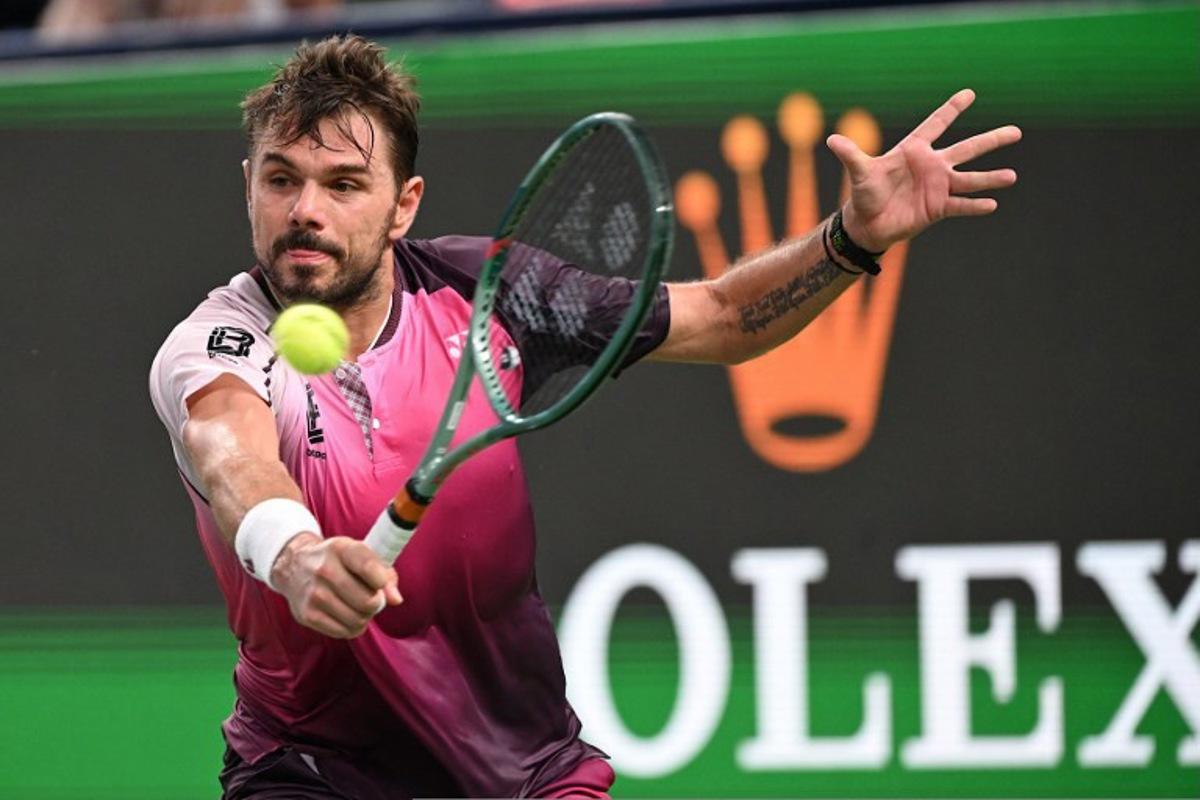 Switzerland's Stan Wawrinka hits a return to Hungary's Fabian Marozsan in their men's singles match at the Shanghai Masters tennis tournament in Shanghai on October 1, 2025.  Jade Gao / AFP
