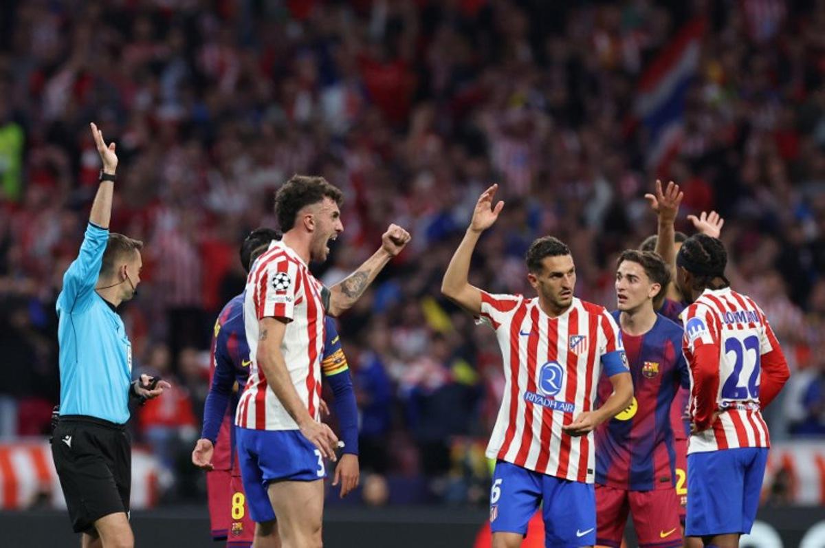 Atletico Madrid's Italian defender #03 Matteo Ruggeri and Atletico Madrid's Spanish midfielder #06 Koke celebrate as French referee Clement Turpin rules offsides on a Barcelona goal during the UEFA Champions League quarter final second leg football match between Club Atletico de Madrid and FC Barcelona at Metropolitano Stadium in Madrid on April 14, 2026.  Oscar DEL POZO / AFP