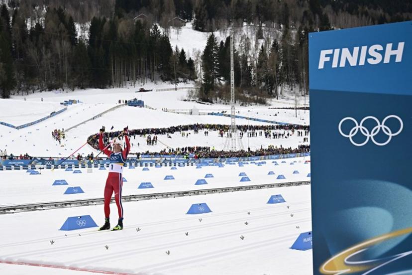 Norway's Johannes Hoesflot Klaebo celebrates as he crosses the finish line to win gold in the men's cross country 50km mass start final event of the Milano Cortina 2026 Winter Olympic Games at Tesero Cross-Country Skiing Stadium in Lago di Tesero (Val di Fiemme) on February 21, 2026.  Tobias SCHWARZ / AFP