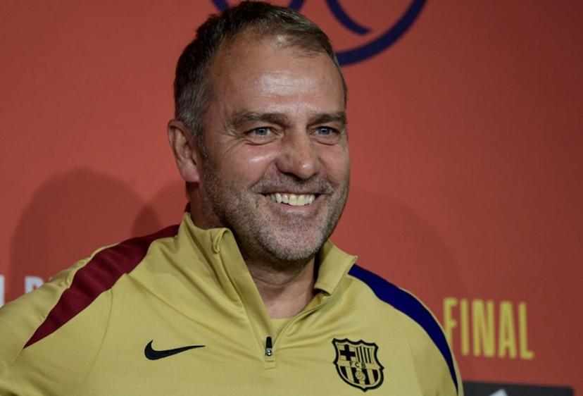 Barcelona's German coach Hans-Dieter Flick smiles during a press conference at La Cartuja stadium on the eve of their Spanish Cup (King's Cup) final between FC Barcelona and Real Madrid CF in Seville, on April 25, 2025.  CRISTINA QUICLER / AFP