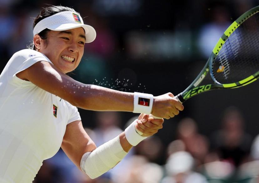 Philippines' Alexandra Eala returns to Italy's Jasmine Paolini during their women's singles round of 16 tennis match on the eighth day of the 2026 Wimbledon Championships at The All England Lawn Tennis and Croquet Club in Wimbledon, southwest London, on July 6, 2026.  Adrian Dennis / AFP