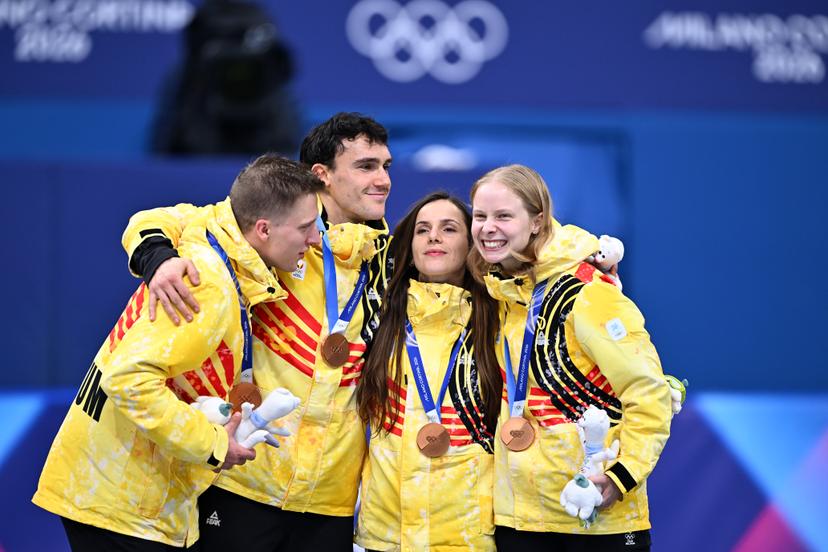 Belgian shorttrack skater Ward Petre, Belgian shorttrack skater Stijn Desmet, Belgian shorttrack skater Hanne Desmet and Belgian shorttrack skater Tineke den Dulk celebrate their bronze medal on the podium of the Mixed Team Relay of the Short Track Speed Skating competition at the Milano Cortina 2026 Olympic Winter Games, on Tuesday 10 February 2026 in Milan, Italy. The XXV Winter Olympics take place from 6 to 22 February 2026 in Italy. BELGA PHOTO JASPER JACOBS