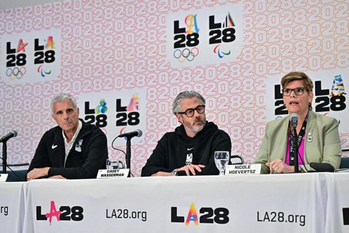 (L/R) LA28 CEO Reynold Hoover, LA28 Chairperson and President Casey Wasserman, and IOC Vice President and LA28 Coordination Commiussion chairperson Nicole Hoevertsz participate in a press conference with the International Olympic Committee (IOC) Coordination Commission for the Los Angeles 2028 Olympic and Paralympic Games, at the LA Convention Center in Los Angeles on June 5, 2025.  Frederic J. Brown / AFP