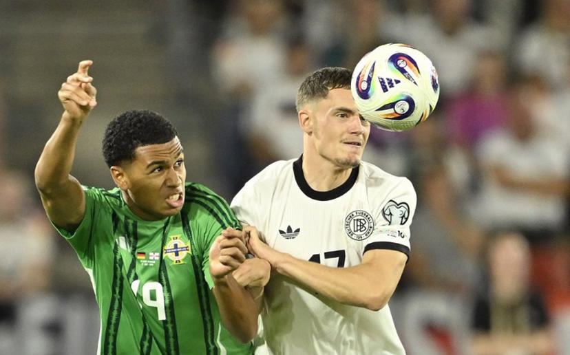 Germany's midfielder #17 Florian Wirtz (R) and Northern Ireland's defender #19 Shea Charles  vie for the ball during the 2026 World Cup qualifiers Europe zone group A football match between Germany and Northern Ireland on September 7, 2025 in Cologne, western Germany.  INA FASSBENDER / AFP