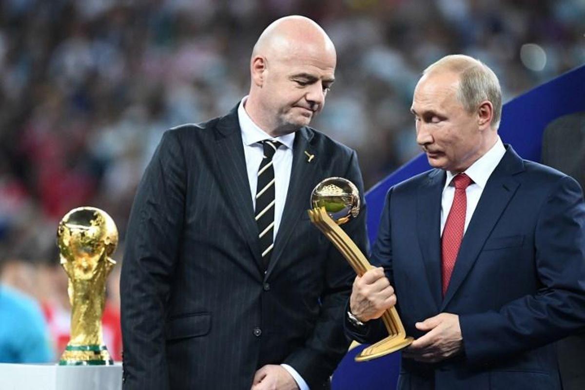 Russian President Vladimir Putin holds the adidas Golden Ball prize beside FIFA president Gianni Infantino (L) during the trophy ceremony at the end of the Russia 2018 World Cup final football match between France and Croatia at the Luzhniki Stadium in Moscow on July 15, 2018.  FRANCK FIFE / AFP RESTRICTED TO EDITORIAL USE - NO MOBILE PUSH ALERTS/DOWNLOADS

