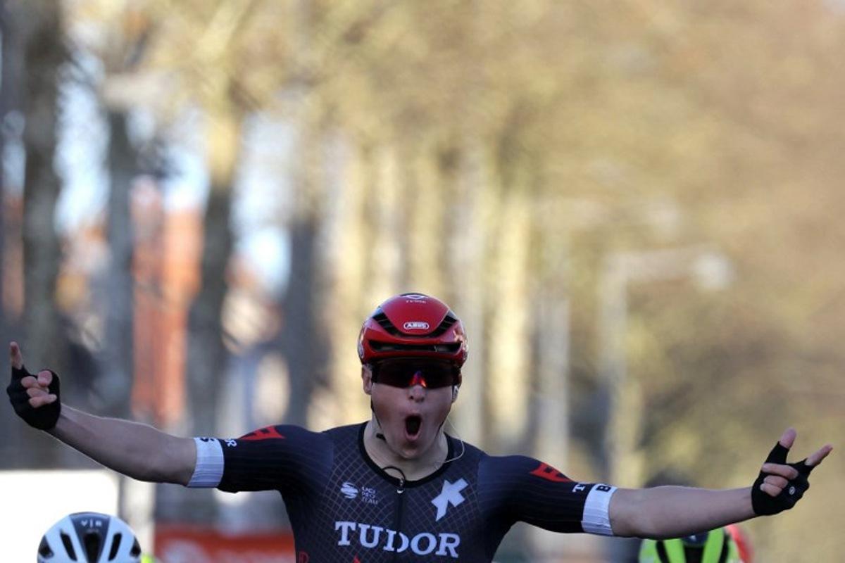 Tudor Pro Cycling Team's Dutch cyclist Arvid De Kleijn celebrates as he crosses the finish line during the 2nd stage of the Paris-Nice cycling race, 179 km between Thoiry and Montargis, on March 4, 2024.  Thomas SAMSON / AFP