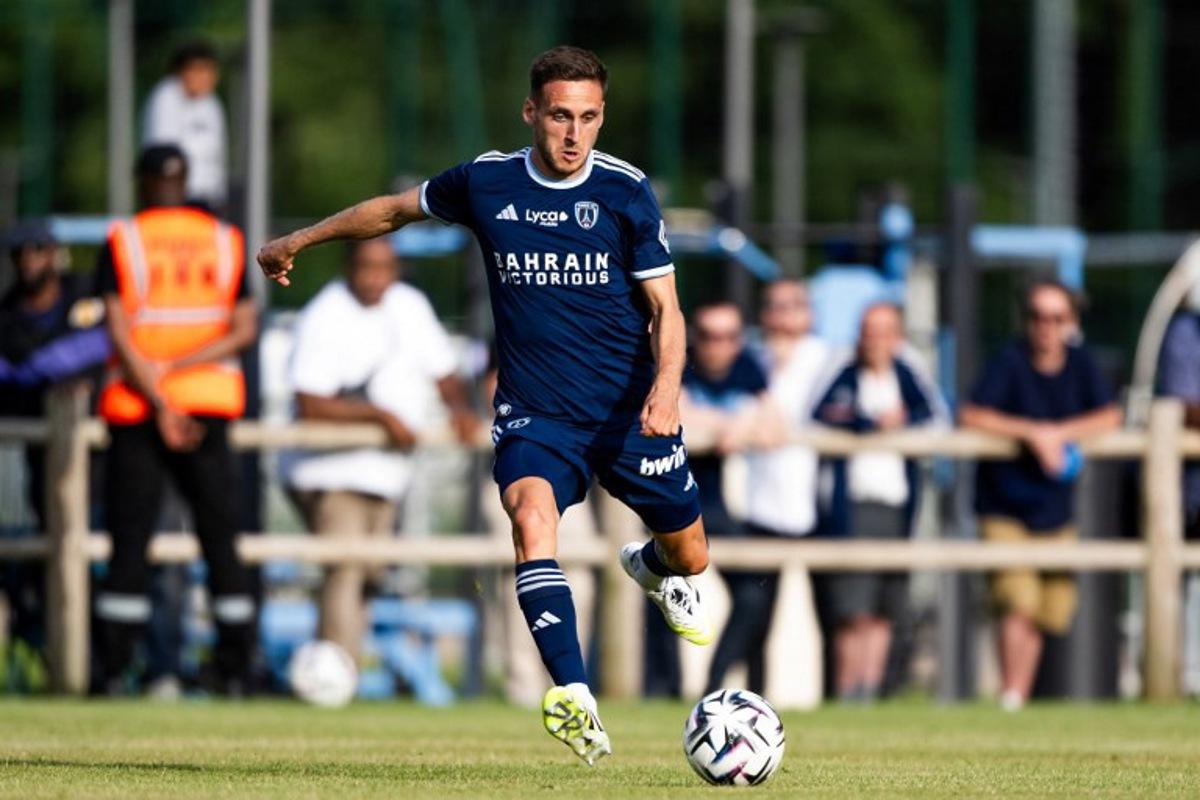 Paris FC's French defender Jules Gaudin runs with the ball during a friendly football match between Paris FC and UNFP (National Union of Professional Footballers) at the Marcel Bec Sports Complex, in Meudon, southwestern of Paris, on August 6, 2025.  Julie SEBADELHA / AFP