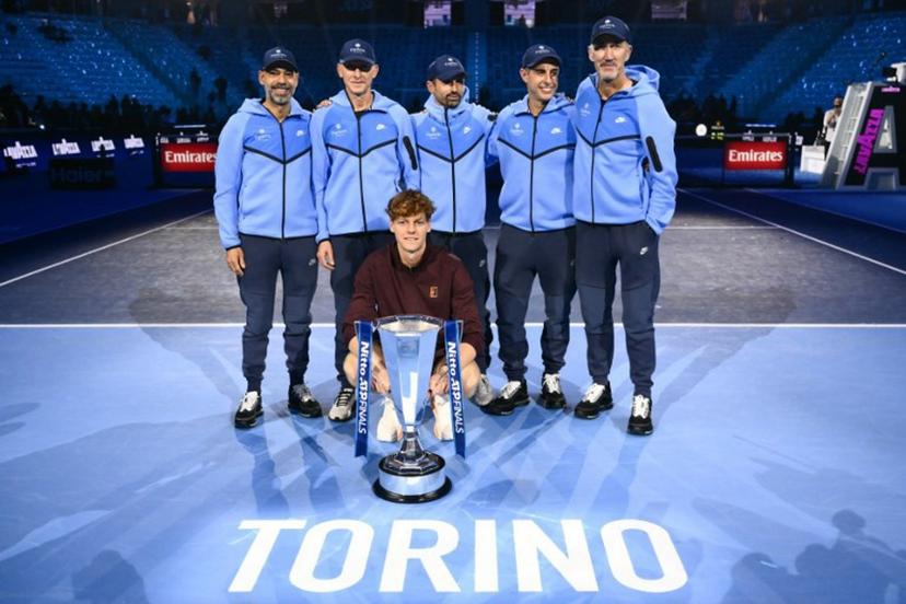 Italy's Jannik Sinner and members of this team pose with the trophy at the end of the men's single final match at the ATP Finals tennis tournament, in Turin, on November 16, 2025.  Marco BERTORELLO / AFP