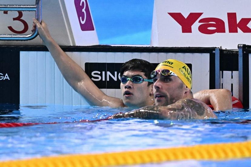 China's swimmer Pan Zhanle (L) and Australia's swimmer Kyle Chalmers react after a semi-final of the men's 100m freestyle swimming event during the 2025 World Aquatics Championships in Singapore on July 30, 2025.  MANAN VATSYAYANA / AFP