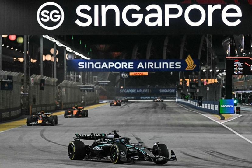 Mercedes' British driver George Russell leads ahead of Red Bull Racing's Dutch driver Max Verstappen during the Formula One Singapore Grand Prix night race at the Marina Bay Street Circuit in Singapore on October 5, 2025.  Lillian SUWANRUMPHA / AFP