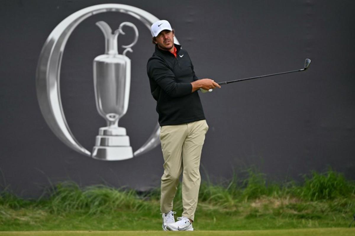 US golfer Brooks Koepka watches his shot from the 1st tee on the opening day of the 153rd Open Championship at Royal Portrush golf club in Northern Ireland on July 17, 2025.  Glyn KIRK / AFP
