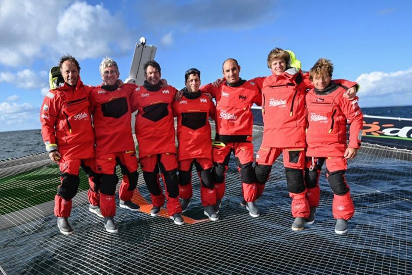 From L: French skipper Thomas Coville, Frederic Denis, Nicolas Troussel,Guillaume Pirouelle (C), Benjamin Schwartz, Leonard Legrand and Pierre Leboucher (R) pose for a photograph aboard the Sodebo Ultim 3 multihull during a training session before an attempt to win the Jules Verne trophy, off Lorient, Western France on November 22, 2024. The Jules Verne trophy is a prize for the fastest circumnavigation of the world by any type of yacht. Seven skippers of the Sodebo team will try to win the Jules Verne Trophy. Sebastien Salom-Gomis / AFP