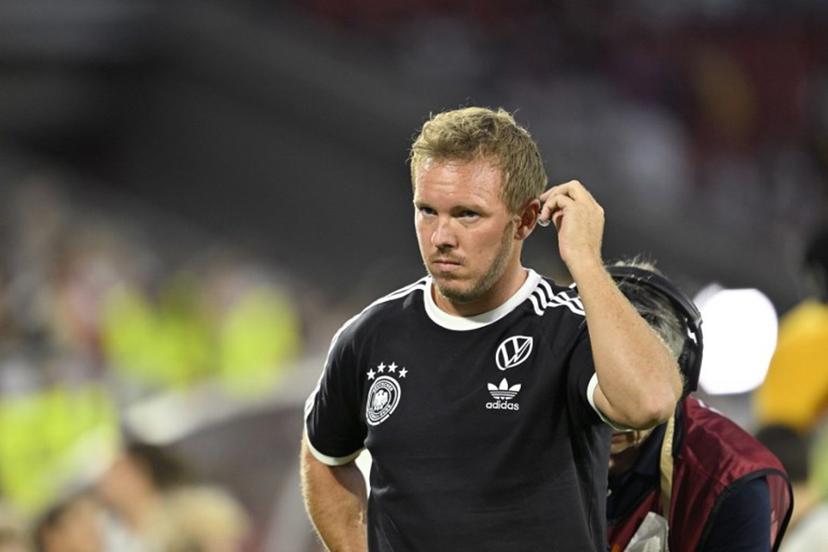 Germany's headcoach Julian Nagelsmann adjusts the earpiece as he wears the national team jersey prior to the start of the 2026 World Cup qualifiers Europe zone group A football match between Germany and Northern Ireland on September 7, 2025 in Cologne, western Germany.  INA FASSBENDER / AFP