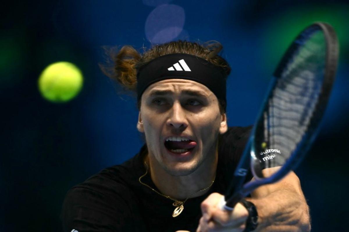 Germany's Alexander Zverev hits the ball during his match against USA's Ben Shelton at the ATP Finals tennis tournament in Turin on November 9, 2025.  Marco BERTORELLO / AFP