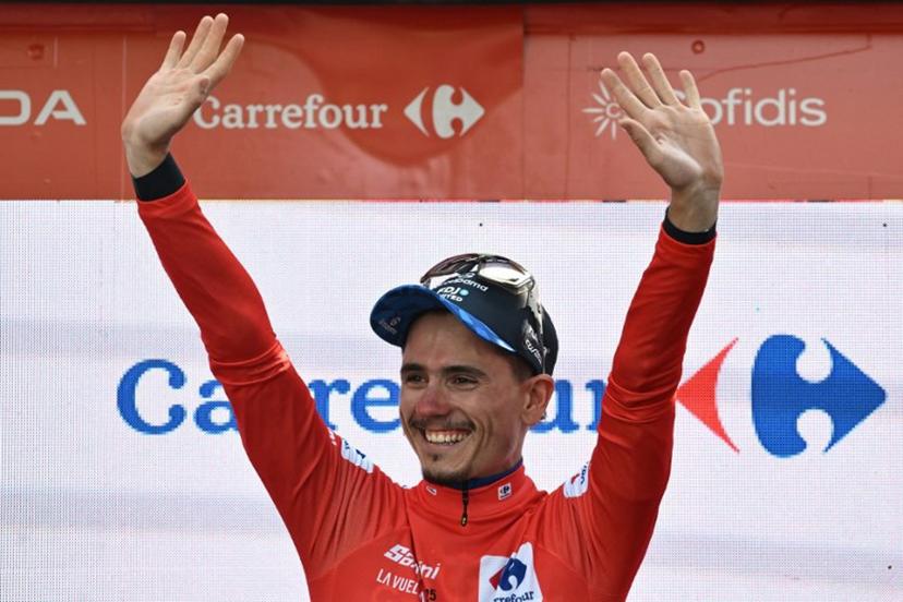 Team Groupama-FDJ's French rider David Gaudu celebrates on the podium wearing the overall leader's red jersey after the fourth stage of the Vuelta a Espana, a 192 km race between Susa and Voiron, in the Alps, on August 26, 2025.    Jeff PACHOUD / AFP