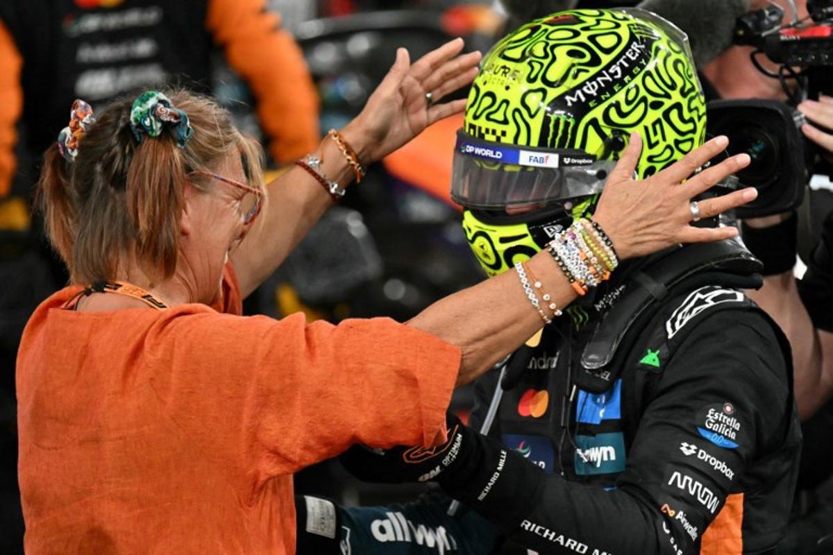 McLaren's British driver Lando Norris (R) celebrates with his family member after finishing the race third to win the world championship title at the end of the Abu Dhabi Formula One Grand Prix at the Yas Marina Circuit in Abu Dhabi on December 7, 2025.  Andrej ISAKOVIC / AFP