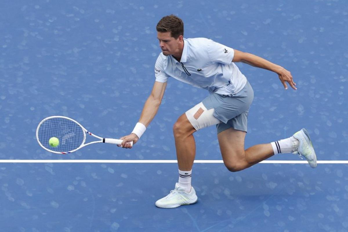 Belgium's Alexander Blockx hits a return to Argentina's Francisco Cerundolo in their men's singles round of 16 tennis match on day nine of the US Open tennis tournament at the USTA Billie Jean King National Tennis Center in New York on September 7, 2026.  KENA BETANCUR / AFP