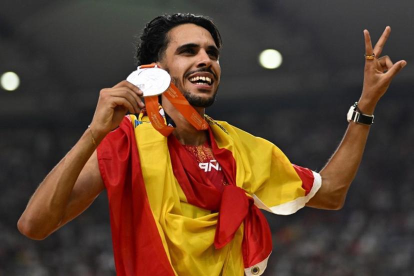 Spain's silver medallist Mohamed Katir celebrates with his medal and national flag after finishing second in the men's 5000m final during the World Athletics Championships at the National Athletics Centre in Budapest on August 27, 2023.  Jewel SAMAD / AFP