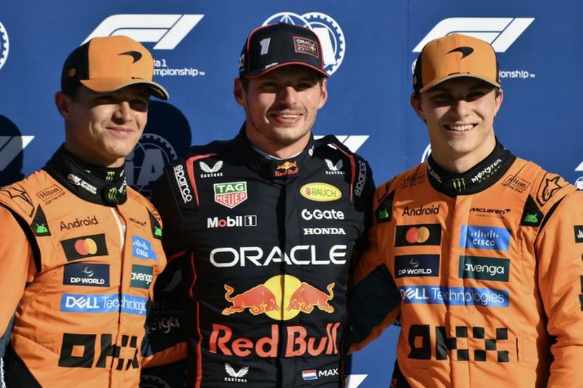 Red Bull Racing's Dutch driver Max Verstappen (C) celebrates his pole position with second placed McLaren's British driver Lando Norris (L) and third-placed McLaren's Australian driver Oscar Piastri (R) after the qualifying session ahead of the Italian Formula One Grand Prix at the Autodromo Nazionale Monza circuit, in Monza, northern Italy, on September 6, 2025.  Marco BERTORELLO / AFP