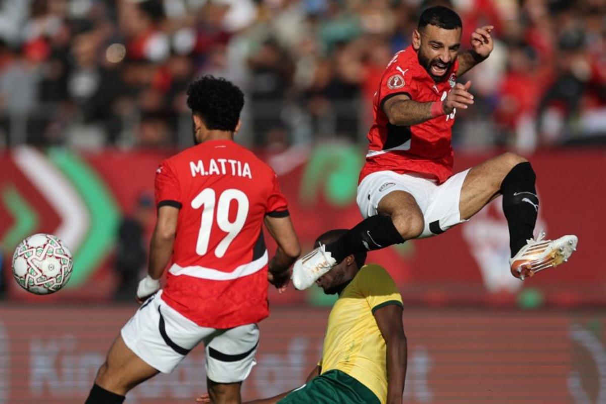 Egypt's forward #10 Mohamed Salah jumps for the ball during the Africa Cup of Nations (CAN) Group B football match between Egypt and South Africa at Adrar Stadium in Agadir on December 26, 2025.   FRANCK FIFE / AFP