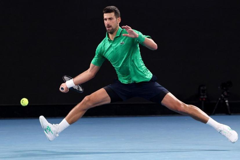 Serbia's Novak Djokovic hits a return to Spain's Pedro Martinez during their men's singles match on day two of the Australian Open tennis tournament in Melbourne on January 19, 2026.  DAVID GRAY / AFP