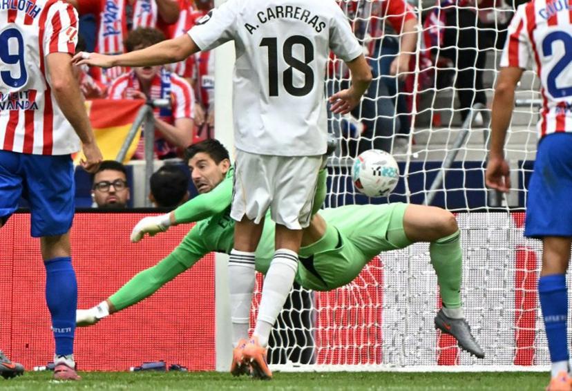 Atletico Madrid's Argentine forward #19 Julian Alvarez scores his team's fourth goal in spite of Real Madrid's Belgian goalkeeper #01 Thibaut Courtois during the Spanish league football match between Club Atletico de Madrid and Real Madrid CF at the Metropolitano stadium in Madrid on September 27, 2025.  Javier SORIANO / AFP