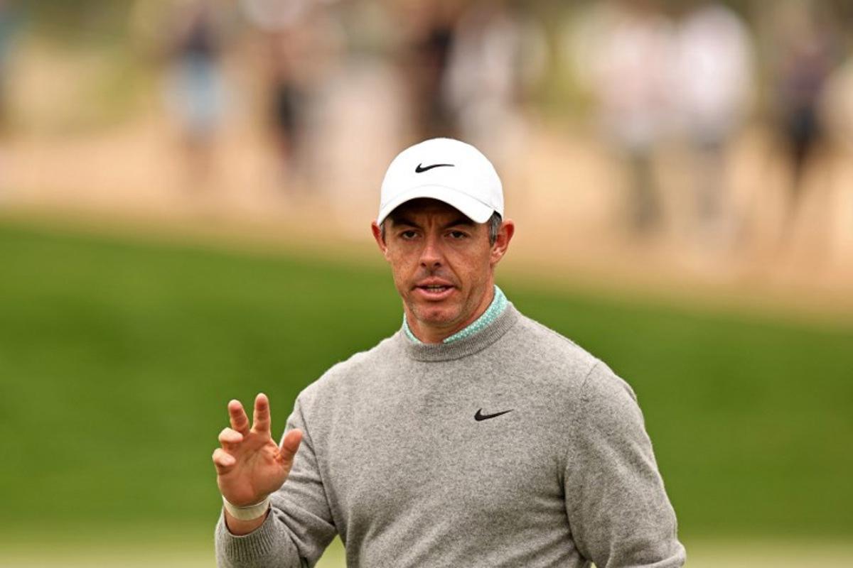 Rory McIlroy of Northern Ireland gestures after playing a shot on the 3rd hole during the Hero Dubai Desert Classic golf tournament at the Emirates Golf Club in Dubai on January 25, 2026.  Fadel SENNA / AFP
