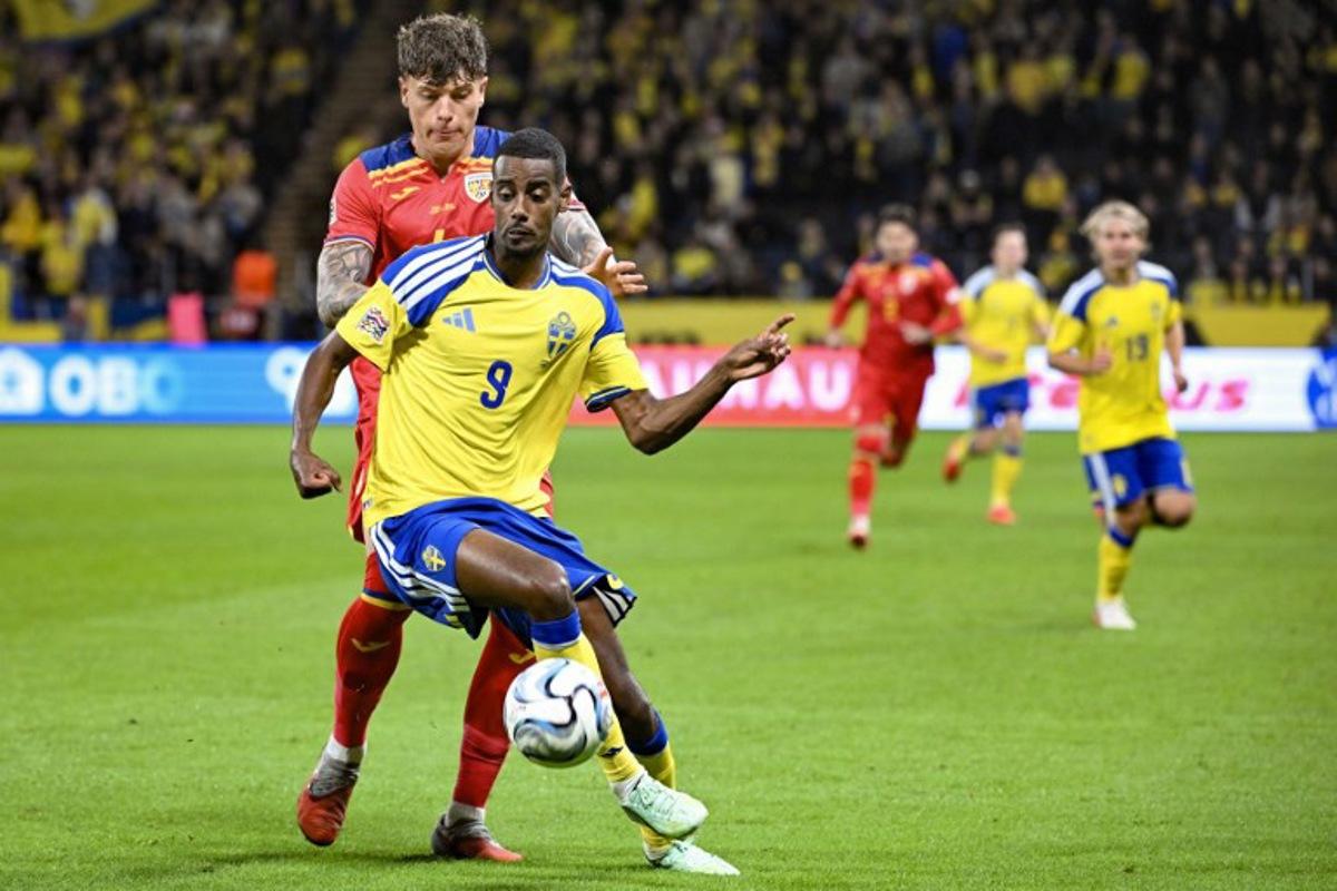 Sweden's forward #09 Alexander Isak and Romania's defender #04 Andrei Coubis vie for the ball during the UEFA Nations League Group B4 football match between Sweden and Romania in Solna, Sweden on September 25, 2026.  Jonathan Nackstrand / AFP