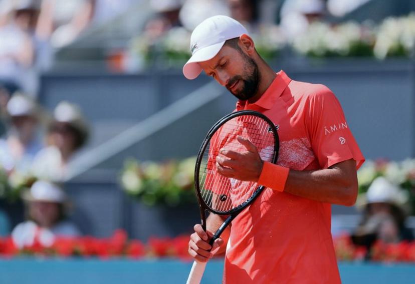 Serbia's Novak Djokovic plays against Italy's Matteo Arnaldi  during their 2025 ATP Tour Madrid Open tennis tournament second round singles match at the Caja Magica in Madrid, on April 26, 2025.  Thomas COEX / AFP