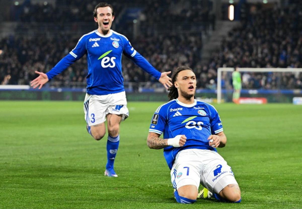 Strasbourg's Belgian midfielder #07 Diego Moreira (R) celebrates scoring his team's second goal during the French L1 football match between RC Strasbourg Alsace and Olympique Lyonnais (OL) at Stade de la Meinau in Strasbourg, eastern France, on February 22, 2026.  SEBASTIEN BOZON / AFP