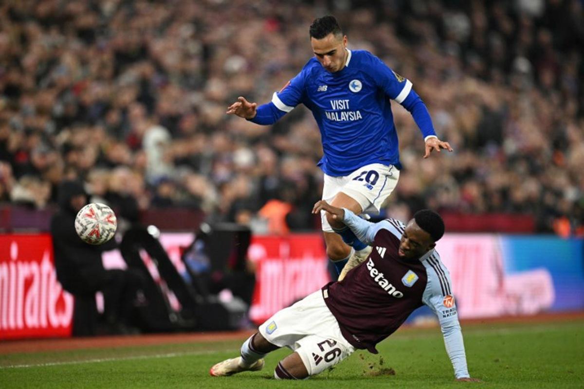 Cardiff City's Dutch striker #20 Anwar El Ghazi battles for the ball with Aston Villa's Dutch midfielder #26 Lamare Bogarde during the English FA Cup fifth round football match between Aston Villa and Cardiff City at Villa Park in Birmingham, central England on February 28, 2025.  Oli SCARFF / AFP