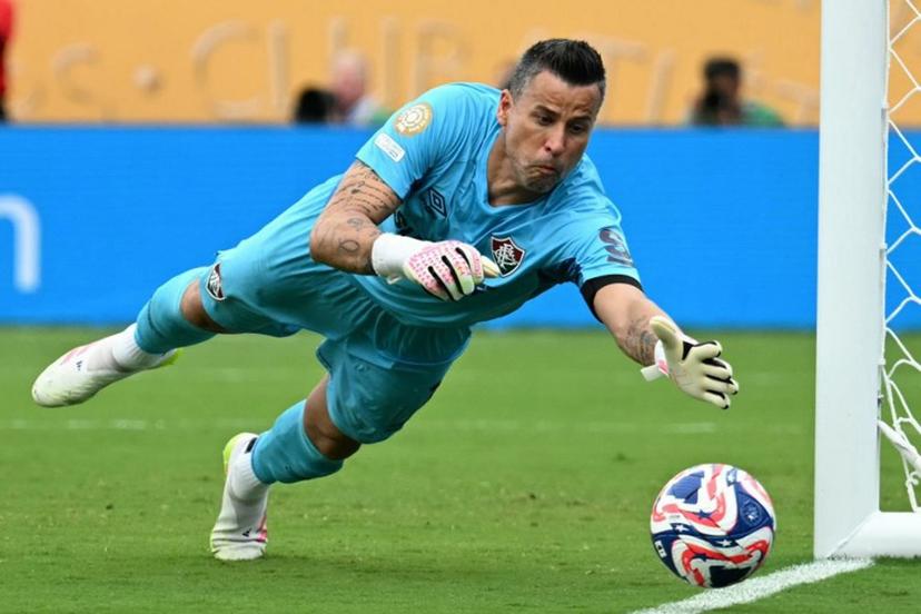 Fluminense's Brazilian goalkeeper #01 Fabio dives to stop a ball during the FIFA Club World Cup 2025 quarterfinal football match between Brazil's Fluminense and Saudi Arabia's Al-Hilal at the Camping World Stadium in Orlando on July 4, 2025.  Chandan Khanna / AFP