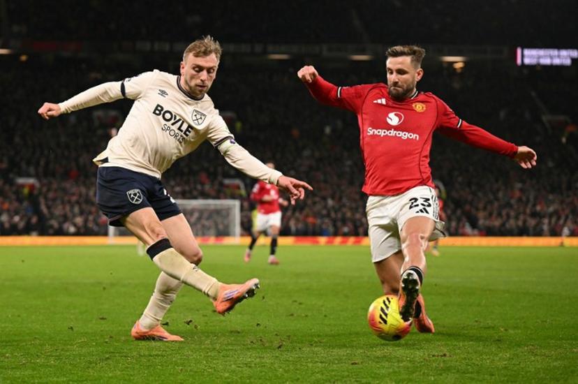 Manchester United's English defender #23 Luke Shaw blocks a cross from West Ham United's English striker #20 Jarrod Bowen during the English Premier League football match between Manchester United and West Ham United at Old Trafford in Manchester, north west England, on December 4, 2025.  Oli SCARFF / AFP