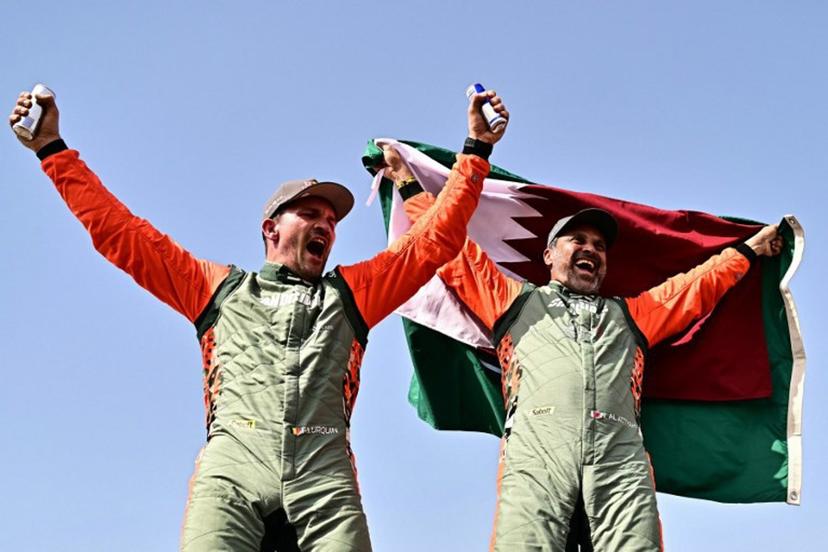 The Dacia Sandriders' Qatari driver Nasser al-Attiyah (R) and Belgian copilot Fabian Lurquin celebrate after winning the 48th edition of the Dakar Rally 2026 in Yanbu, Saudi Arabia, on January 17, 2026. Qatar's Nasser Al-Attiyah secured his sixth Dakar Rally car title in Saudi Arabia. Giuseppe CACACE / AFP