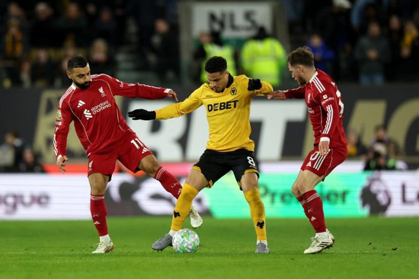 Wolverhampton Wanderers' Brazilian midfielder #08 Joao Gomes is put under pressure by Liverpool's Egyptian striker #11 Mohamed Salah (L) and Liverpool's Argentinian midfielder #10 Alexis Mac Allister during the English Premier League football match between Wolverhampton Wanderers and Liverpool at the Molineux stadium in Wolverhampton, central England on March 3, 2026.  Darren Staples / AFP