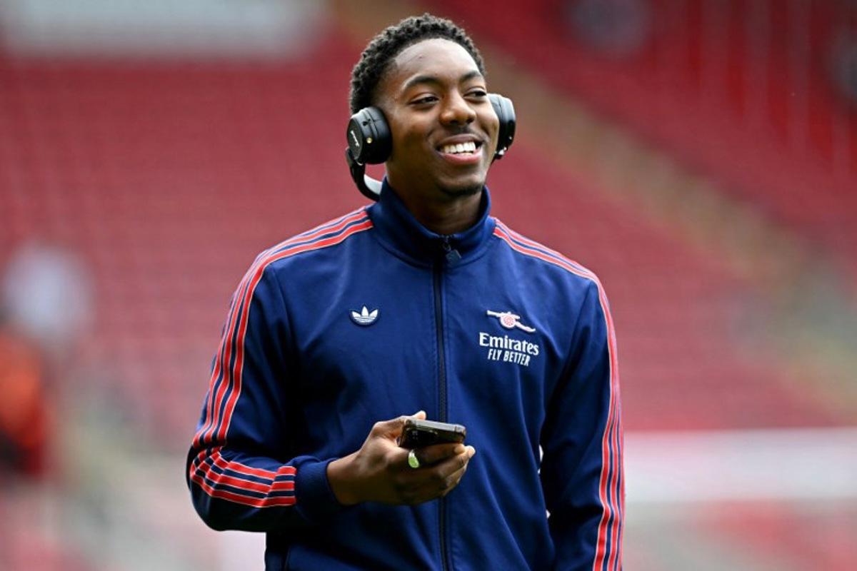 Arsenal's English midfielder #49 Myles Lewis-Skelly walks on the pitch with headphones before the English Premier League football match between Southampton and Arsenal at St Mary's Stadium in Southampton, southern England, on May 25, 2025.  Glyn KIRK / AFP
